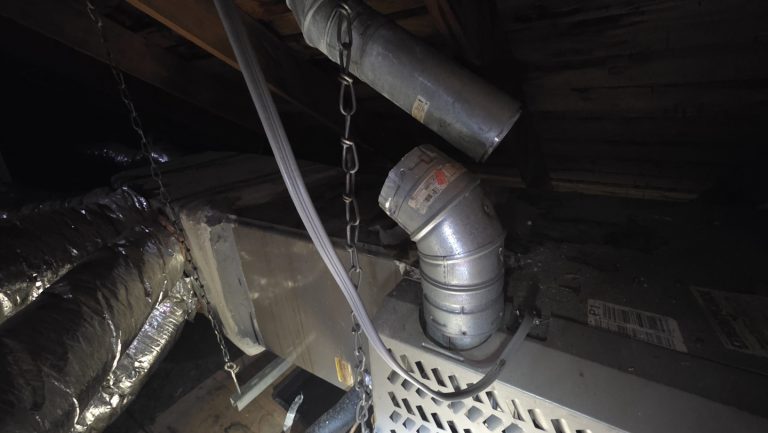 Disconnected metal furnace flue vent found in an attic